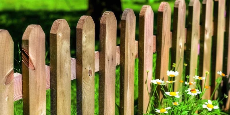 Wooden garden fence with rounded top