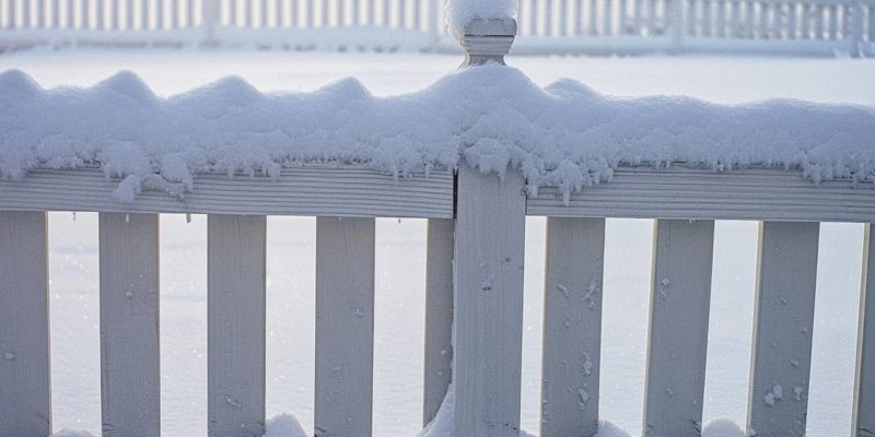 A White Fence Covered in Snow